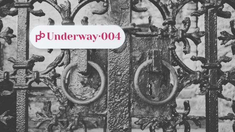 Underway 004 – why bookstores reject self-published books: a locked ornate wrought-iron gate in black and white, two ring handles and a keyhole at its centre, shut against a pale stone wall.